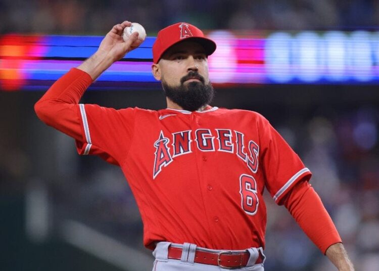 Los Angeles Angels third baseman Anthony Rendon throws the ball into the crowd in the first inning of a baseball game against the Texas Rangers, Tuesday, June 13, 2023, in Arlington, Texas.