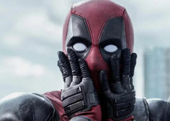 Deadpool looks shocked with his hands on his masked face