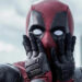 Deadpool looks shocked with his hands on his masked face