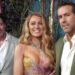 Hugh Jackman, Blake Lively and Ryan Reynolds pose together on the red carpet, smiling at the camera.