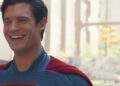 David Corenswet laughs  on the set of Superman.