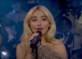 Sabrina Carpenter performing in sparkly dress at SNL 50. .