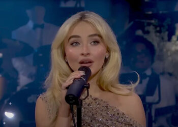 Sabrina Carpenter performing in sparkly dress at SNL 50. .