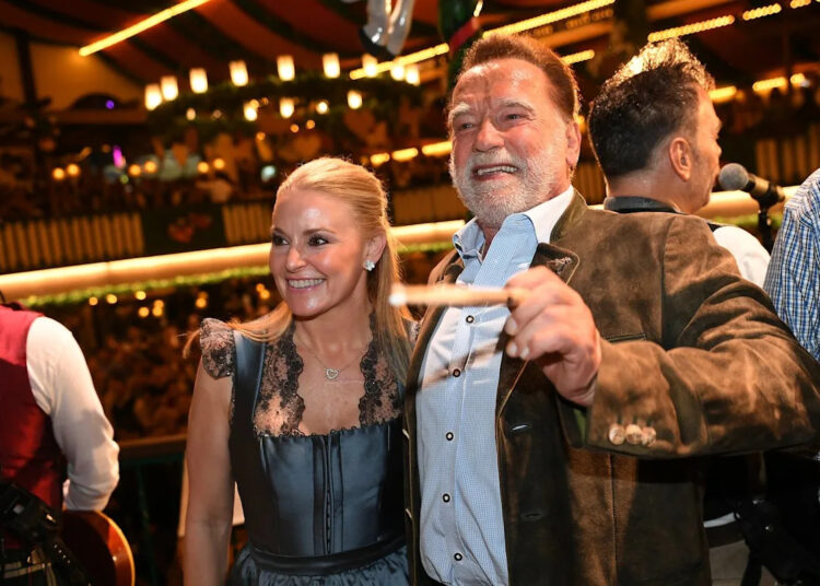Schwarzenegger directs a band in a beer tent at Munich's Oktoberfest
