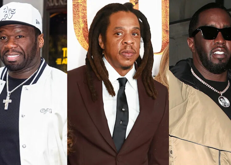 50 Cent in a white jacket and cap, Jay-Z in a suit with dreadlocks, and Diddy in sunglasses and a tan jacket.