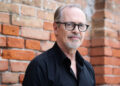 Steve Buscemi in Venice, Italy standing in front of brick wall