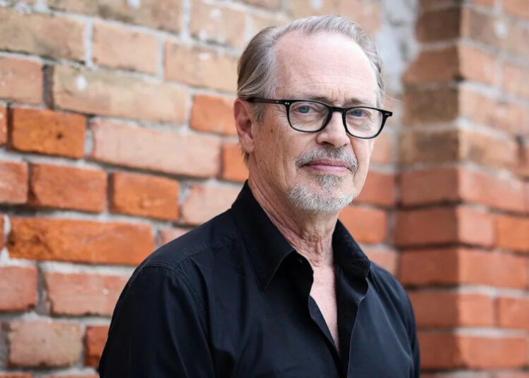 Steve Buscemi in Venice, Italy standing in front of brick wall