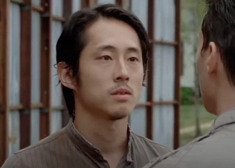 Glenn Rhee (Steven Yeun) has a conversation on The Walking Dead.