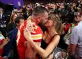 Travis Kelce and Taylor Swift embrace.