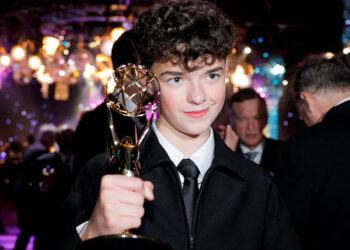 Owen Cooper poses with his trophy for best supporting actor in a limited series