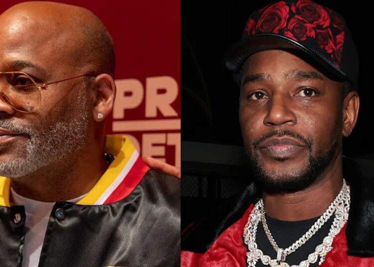 Damon Dash and Cam'ron, both wearing stylish outfits, pose for photos at an event.