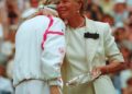 Two blonde women talk in the sunlight