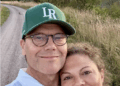 Crown Princess Victoria and Prince Daniel taking a selfie in front of a dirt road with a sunset behind them