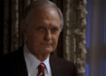 Alan Alda in a suit, looking very serious on The West Wing.