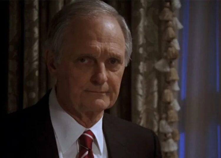 Alan Alda in a suit, looking very serious on The West Wing.