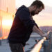 Noah Wyle dramatically leans on a railing at sunrise in The Pitt S1 E1 - "7:00 AM.".