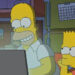 Homer smiling at laptop screen while Bart is bored in The Simpsons.