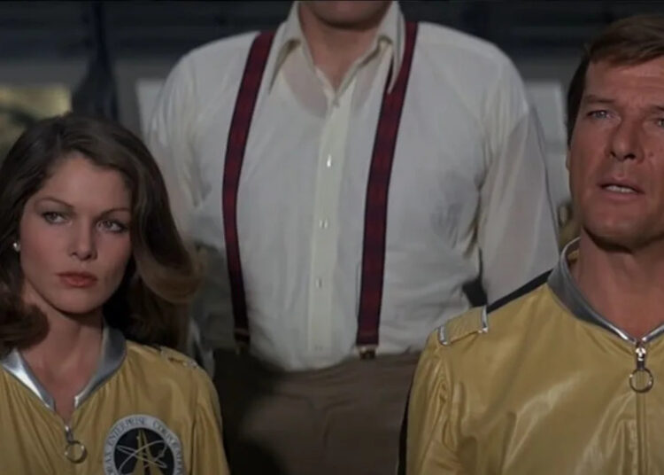 Lois Chiles and Roger Moore standing in uniform in Moonraker.