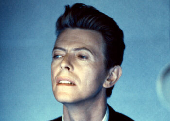 David Bowie in a studio looking wistfully off camera