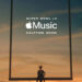 Person sitting on a goalpost crossbar at sunset with text: "Super Bowl LX Apple Music Halftime Show."
