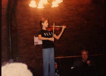 Magee Capsouto as a child playing violin