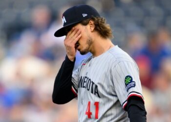 Minnesota Twins starting pitcher Joe Ryan wipes his face after issuing a second walk during the first inning of a baseball game against the Kansas City Royals in Kansas City, Mo., Saturday, Sept. 6, 2025. (AP Photo/Reed Hoffmann)