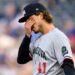 Minnesota Twins starting pitcher Joe Ryan wipes his face after issuing a second walk during the first inning of a baseball game against the Kansas City Royals in Kansas City, Mo., Saturday, Sept. 6, 2025. (AP Photo/Reed Hoffmann)