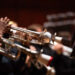 2024 UAB Symphony Band Rehearsal, Alys Stephens Center - Jemison Concert Hall.  From side, hands of several student musicians are playing trumpets while seated on stage, November 2024.