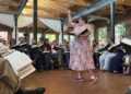 Musicologist Angharad Davis of Australia leads the song she composed for the new edition of The Sacred Harp, "Radiance," in the center of the hollow square.