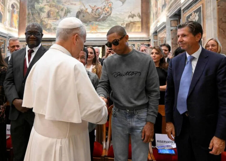 Pope Leo shakes hands with American singer Pharrell Williams at the Vatican, on Friday. A varied mix of thinkers and music artists convened to discuss everything from agriculture to sport. - Simone Risoluti/Vatican Media/Reuters