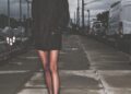victoria beckham standing on a sidewalk in a dark blazer and high heels