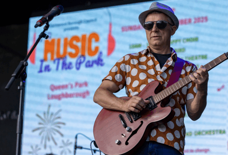 Man plays guitar at Music in the Park