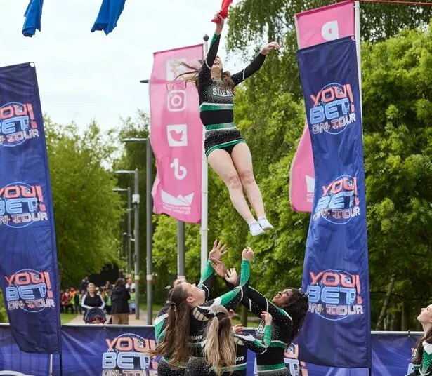 People trying to peg washing on a line suspended high in the air