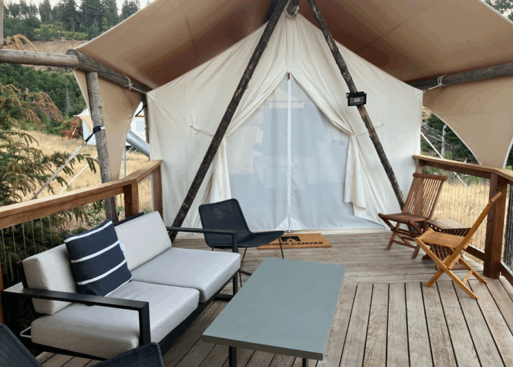 outdoor seating area of a glamping tent with wooden deck
