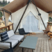 outdoor seating area of a glamping tent with wooden deck