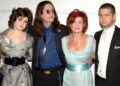 From left to right - Kelly, Ozzy, Sharon and Jack Osbourne pose for a picture at an event.