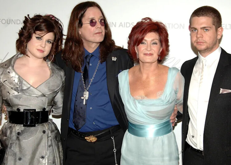 From left to right - Kelly, Ozzy, Sharon and Jack Osbourne pose for a picture at an event.