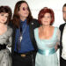 From left to right - Kelly, Ozzy, Sharon and Jack Osbourne pose for a picture at an event.