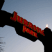 An arch with fiery torches reads "Jurassic Park" in red lettering