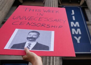 A demonstrator holds a sign outside El Capitan Entertainment Centre, where the late-night show "Jimmy Kimmel Live!" is staged on Thursday, Sept. 18, 2025, in Los Angeles. (AP Photo/Damian Dovarganes)