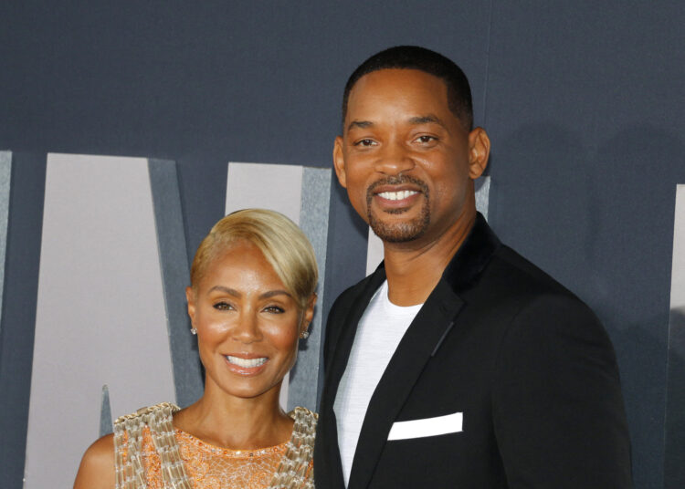 Will Smith and Jada Pinkett Smith smiling together at a red carpet event