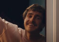 Paul Mescal leaning on door frame in All Of Us Strangers.