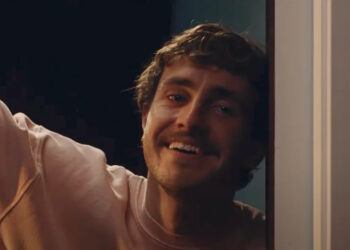 Paul Mescal leaning on door frame in All Of Us Strangers.
