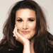 Sam Bailey Sam Bailey looking at the camera with her hand on her chin.