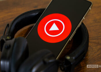 YouTube Music logo on smartphone with headphones