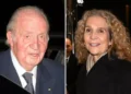 Juan Carlos I and Infanta Elena, a man and a woman, pose smiling at a nighttime event.