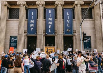 Demonstrators gather outside the El Capitan Theatre in Hollywood, Calif., on Thursday, Sept. 18, where production of