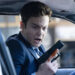 Nathan looking at his hand holding a gun in "Novocaine" (2025)