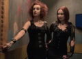 Jen and Sylvia Soska press a button in the Hellevator