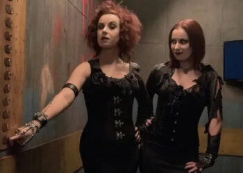 Jen and Sylvia Soska press a button in the Hellevator